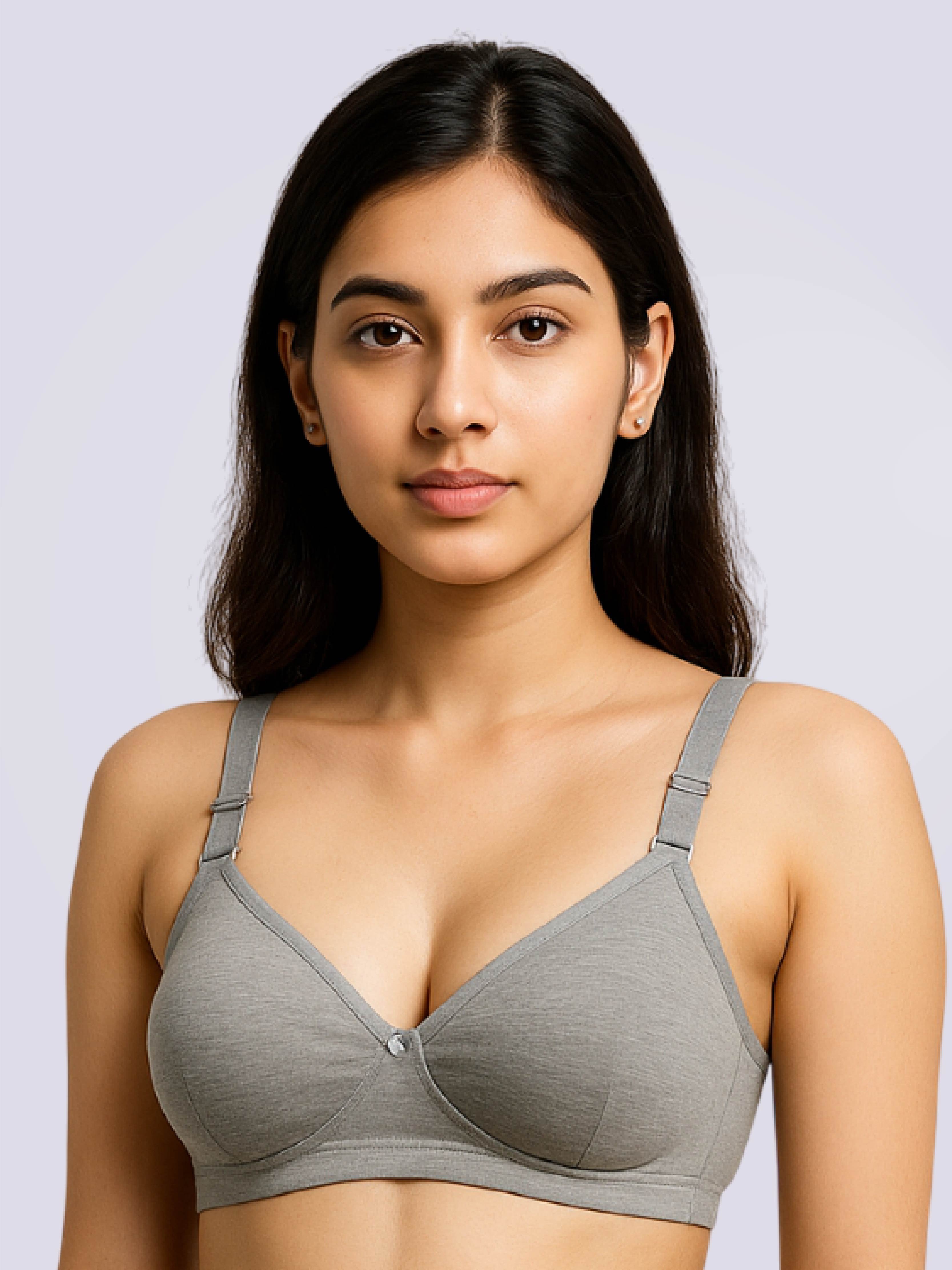 Woman wearing a gray bra against a light gray background